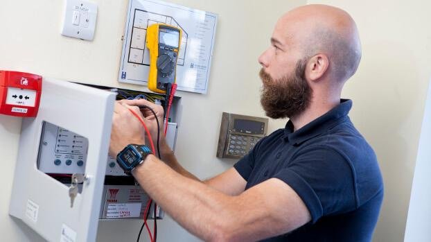 Electrician installing safety equipment